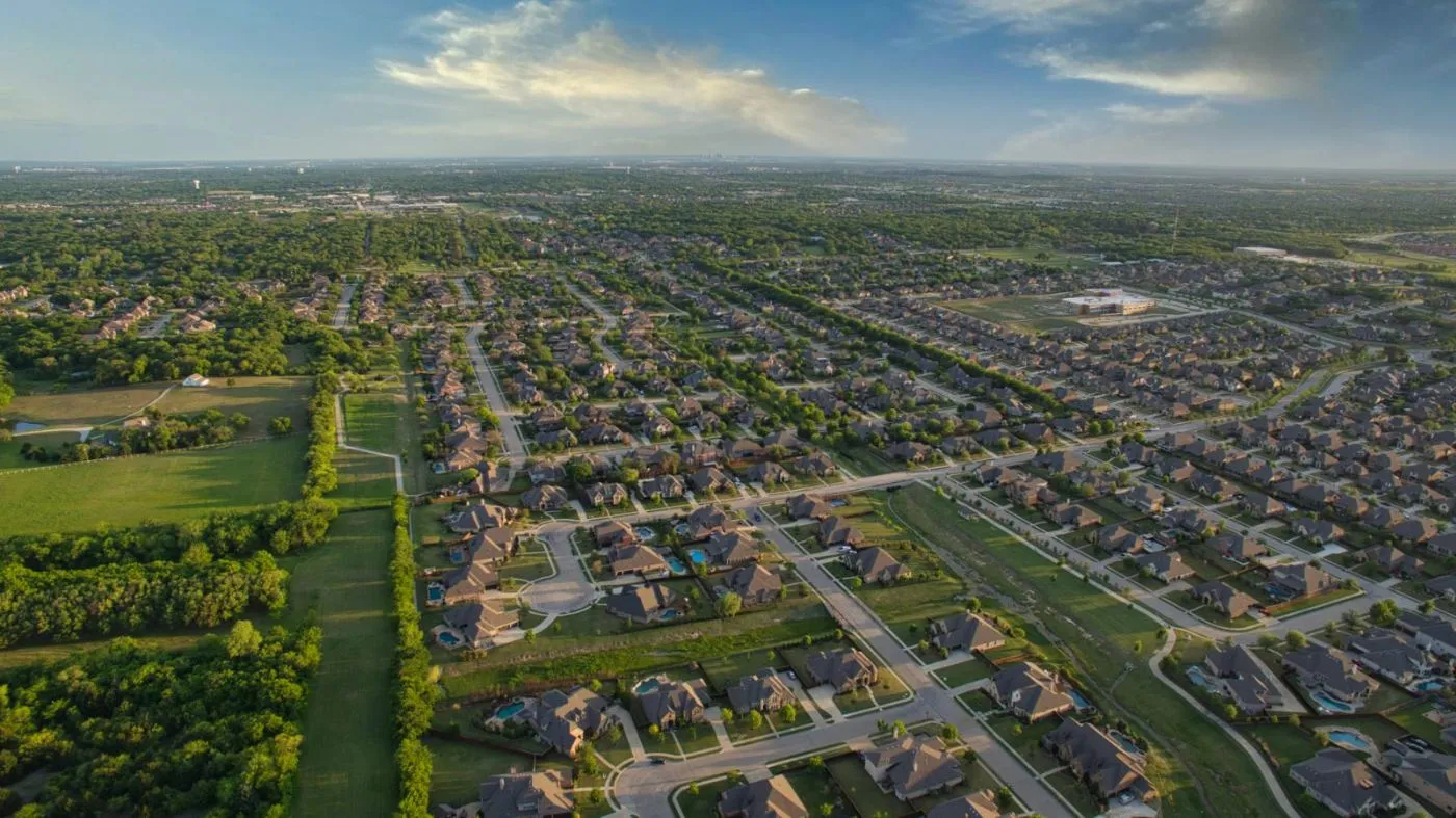 Aerial view of a large residential community with new homes stretching to the horizon