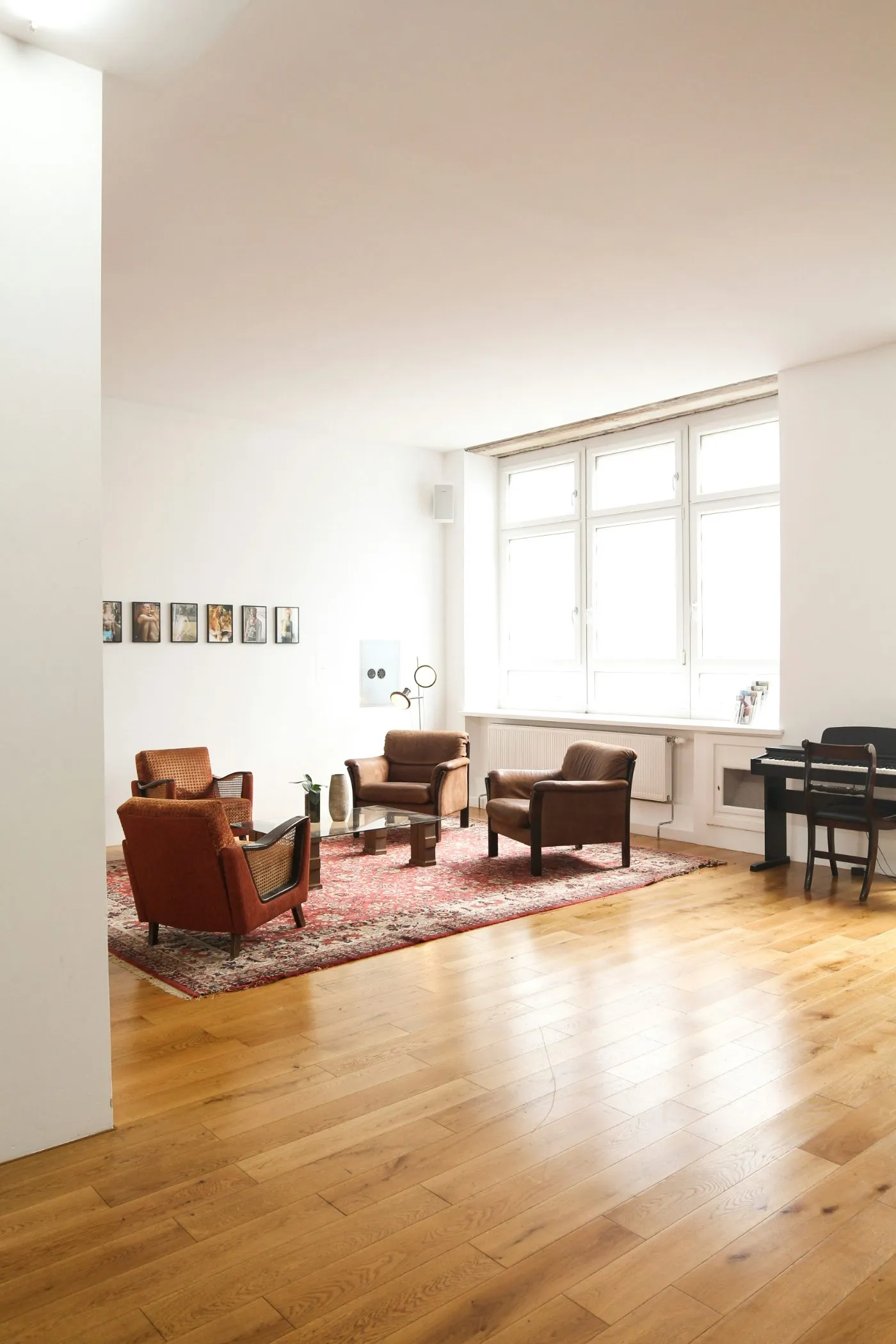 Wide-plank oak hardwood flooring in a bright, white-walled living room