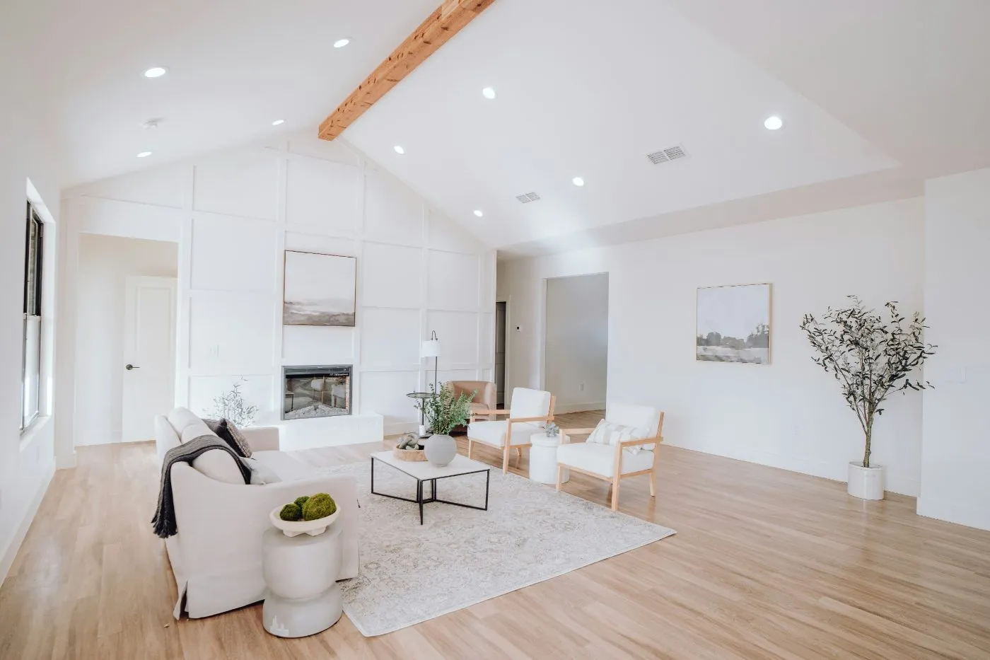 Light oak-look luxury vinyl plank flooring in a bright vaulted living room